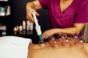 faceless masseur rubbing back of customer